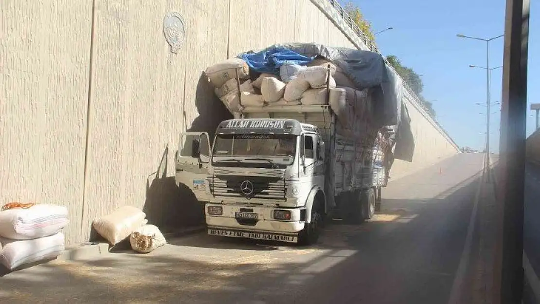 Saman yüklü kamyon alt geçide takıldı, yola savrulan çuvallar trafiği kilitledi